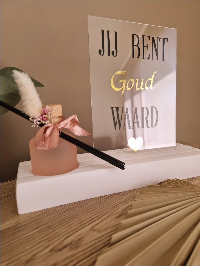Witte kaarthouder met roze geurflesje, afgewerkt met droogbloemetjes en acrylplaat met ""jij bent goud waard"